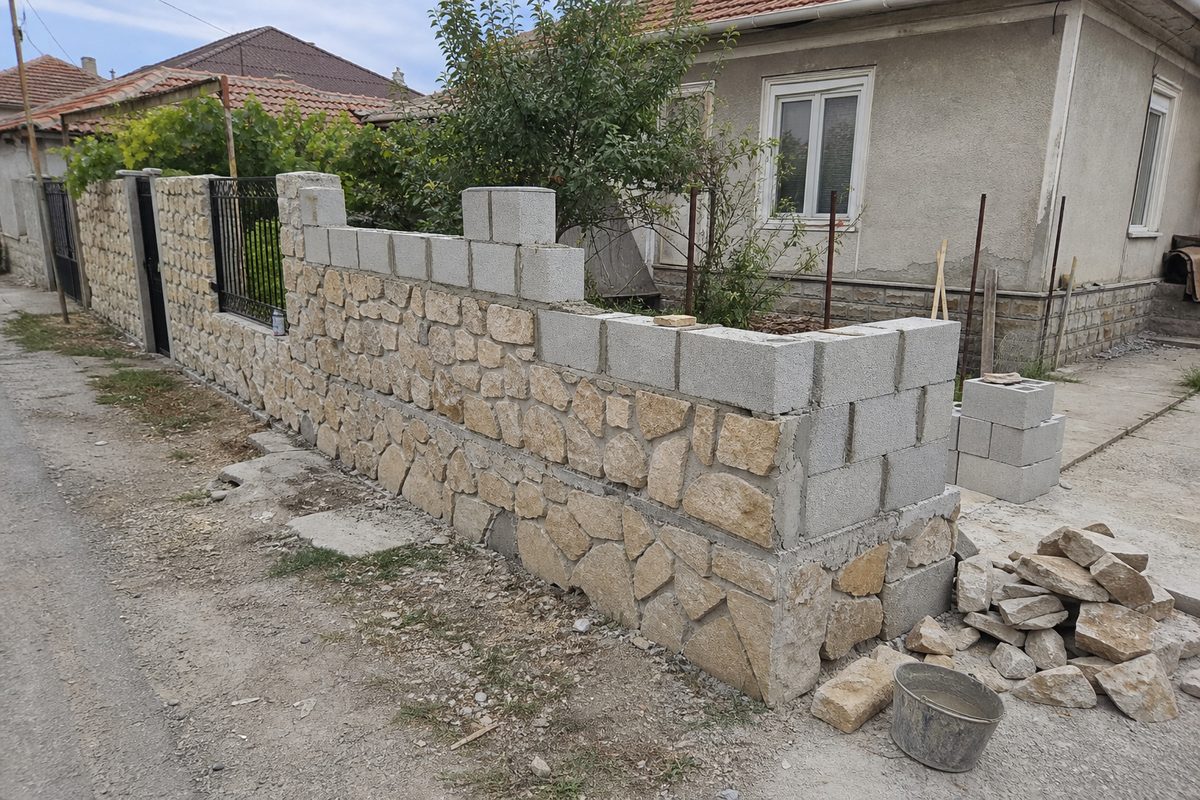 Sample demo image of a part-complete block and stone boundary wall in a Bulgarian residential setting